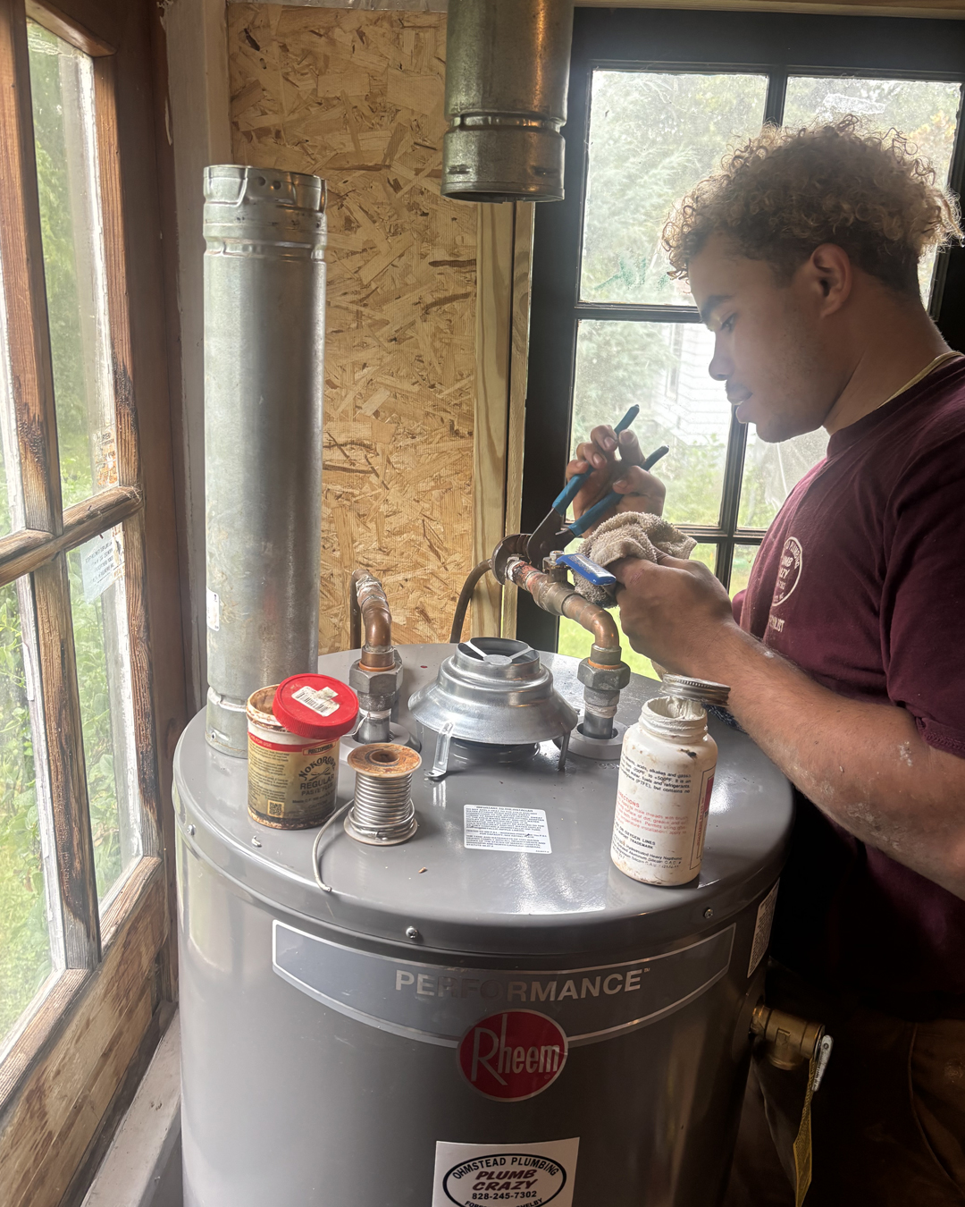 Ohmstead Plumbing technician connecting a new Rheem water heater in a Forest City NC home